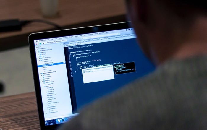 man configuring a system on his laptop computer